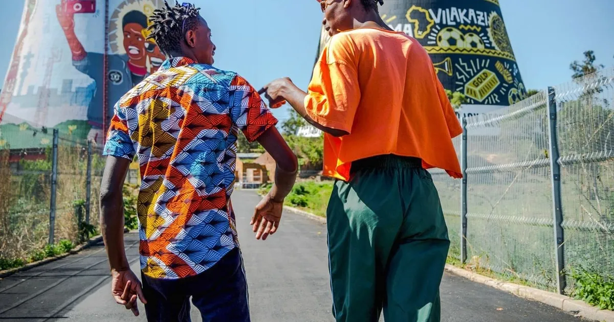 Walking tour group in a Soweto street with a local guide
