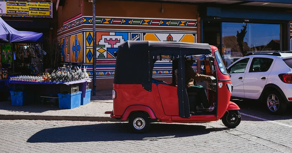 Tuk tuk carrying visitors through Soweto streets