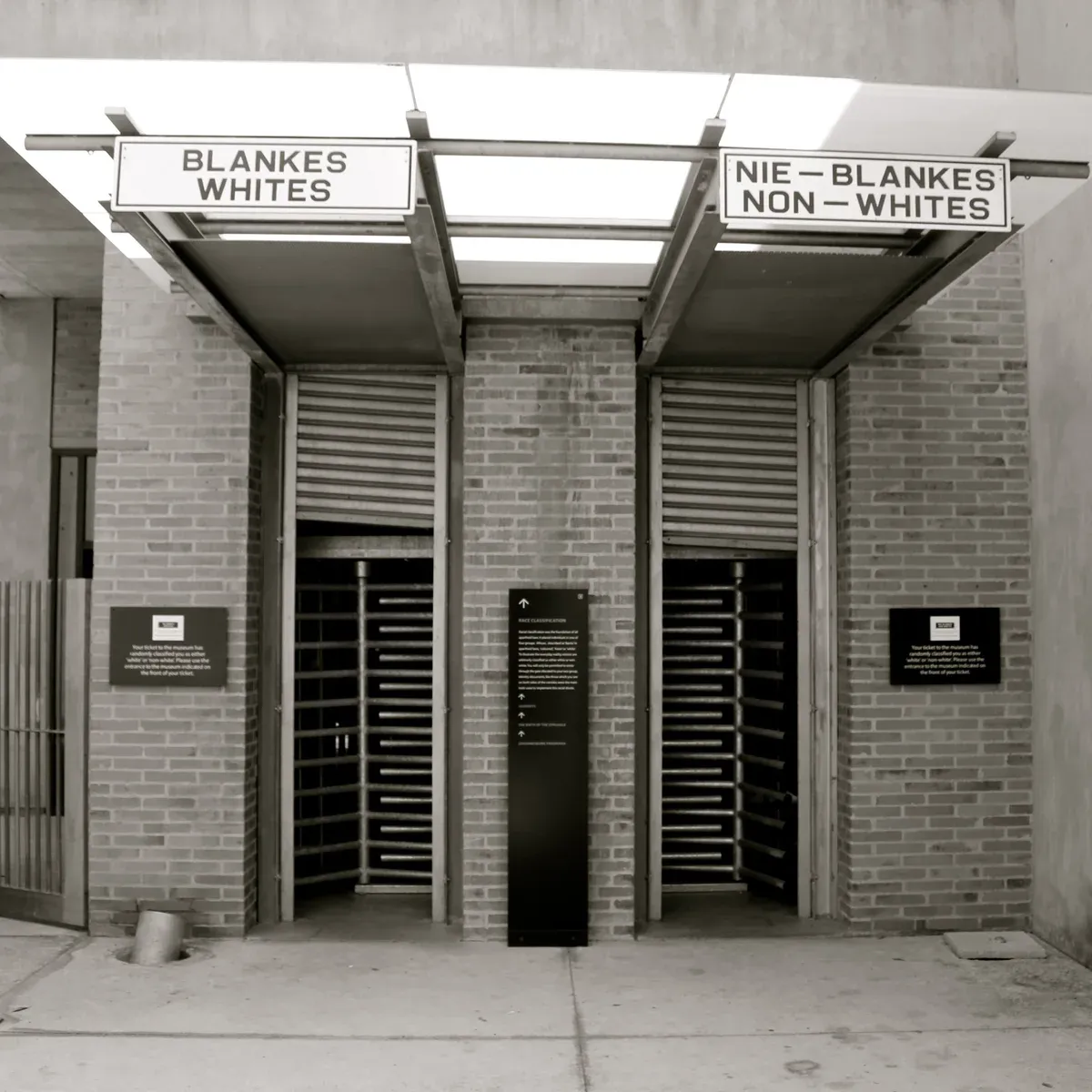 The two segregated entrance ramps at the Apartheid Museum, marked for the racial category printed on the entry ticket