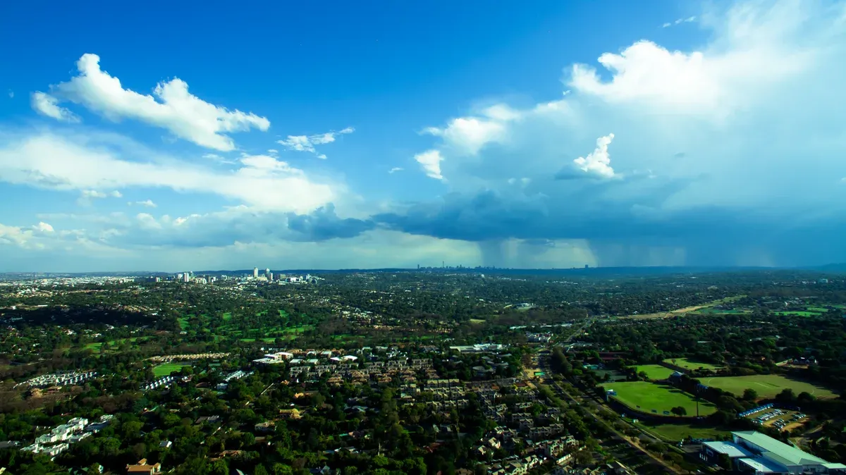 A Johannesburg summer afternoon with towering storm clouds breaking up over the skyline
