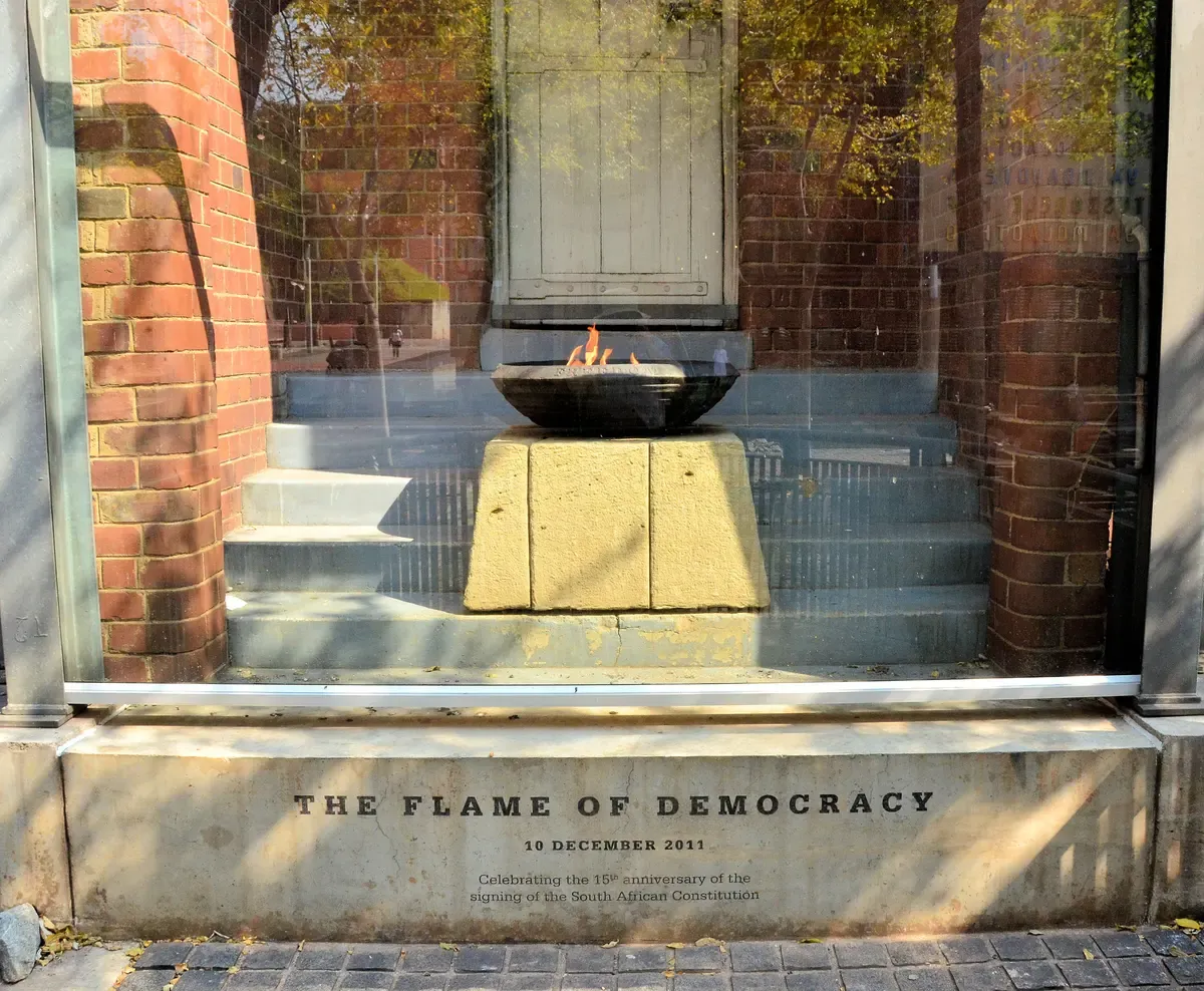 The Flame of Democracy burning in its concrete stairwell casing at Constitution Hill, Johannesburg