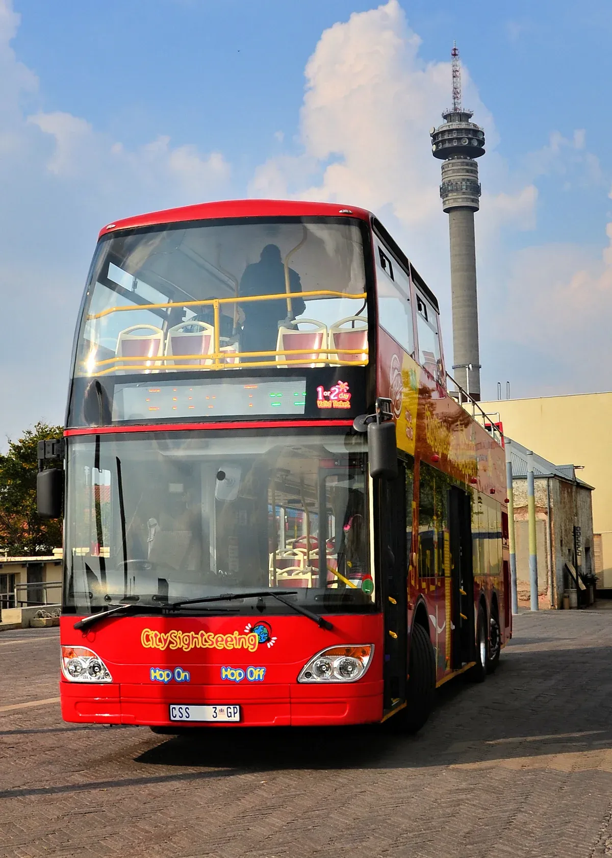 The open-top red City Sightseeing bus waiting at a Johannesburg stop