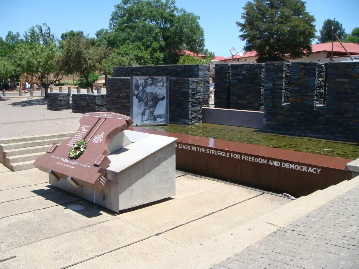 The Hector Pieterson Memorial stone standing in its paved square in Orlando West, Soweto
