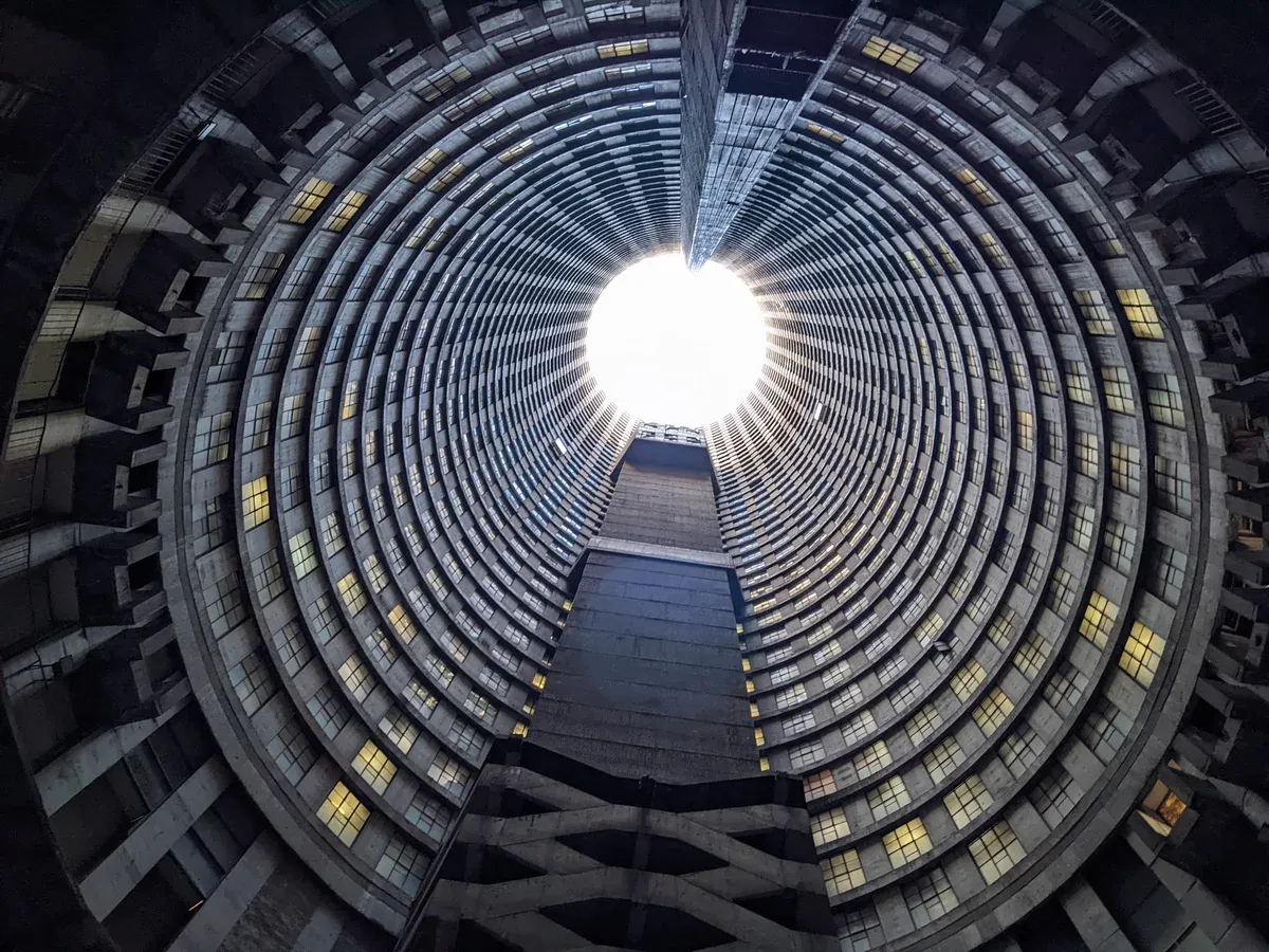 The hollow core of Ponte City seen from the lowest level, balcony rings rising all the way to an open circle of sky